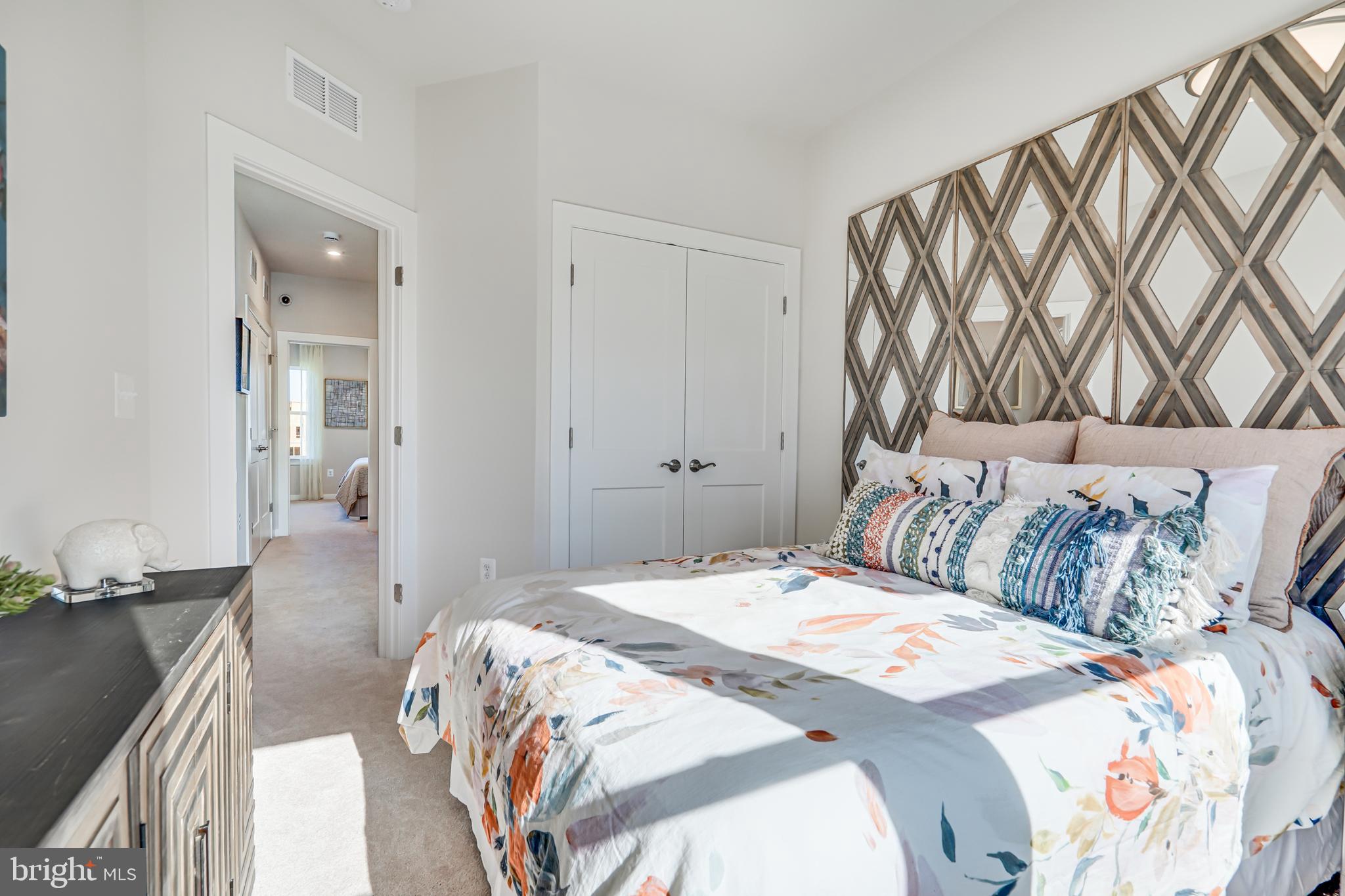 13660 Cobble Loop Woodbridge, VA 22193 - Photo 35 of 44 a bedroom with a large bed and a chandelier