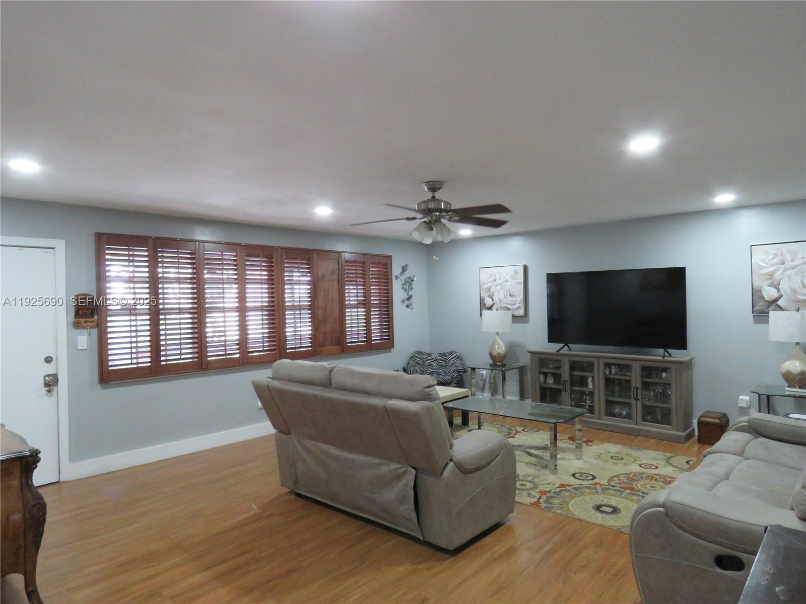 11840 Northeast 19th Drive, Unit 26 North Miami, FL 33181 - Photo 1 of 15 a living room with furniture and a flat screen tv