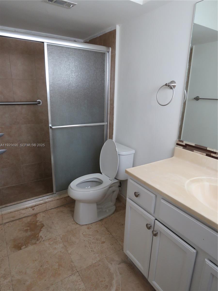 11840 Northeast 19th Drive, Unit 26 North Miami, FL 33181 - Photo 12 of 15 a bathroom with a toilet and a shower