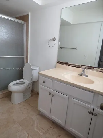 a bathroom with a sink toilet and a mirror