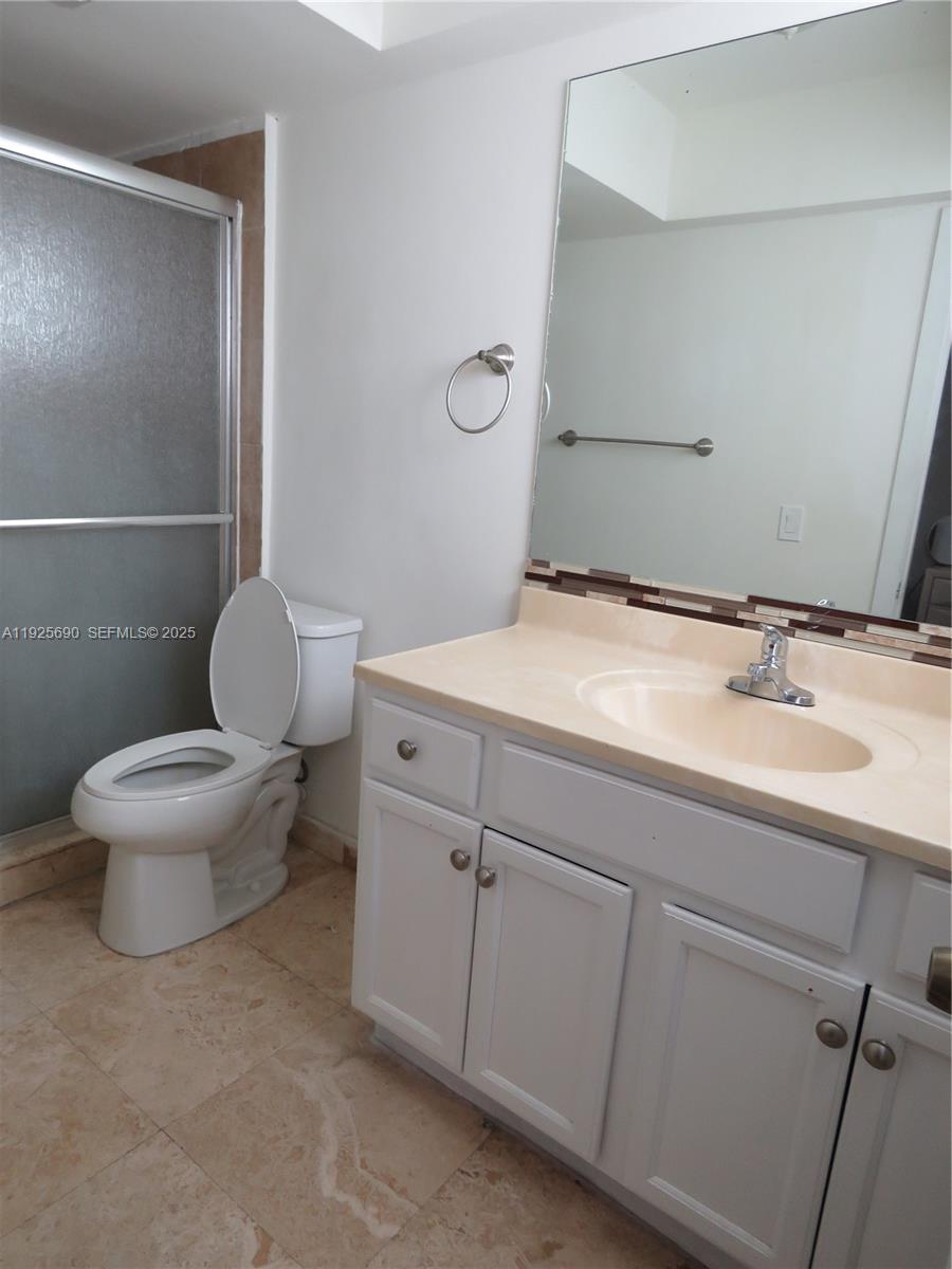 11840 Northeast 19th Drive, Unit 26 North Miami, FL 33181 - Photo 13 of 15 a bathroom with a sink toilet and a mirror