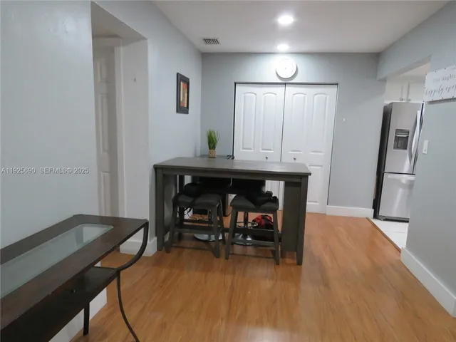a view of a room with furniture and wooden floor