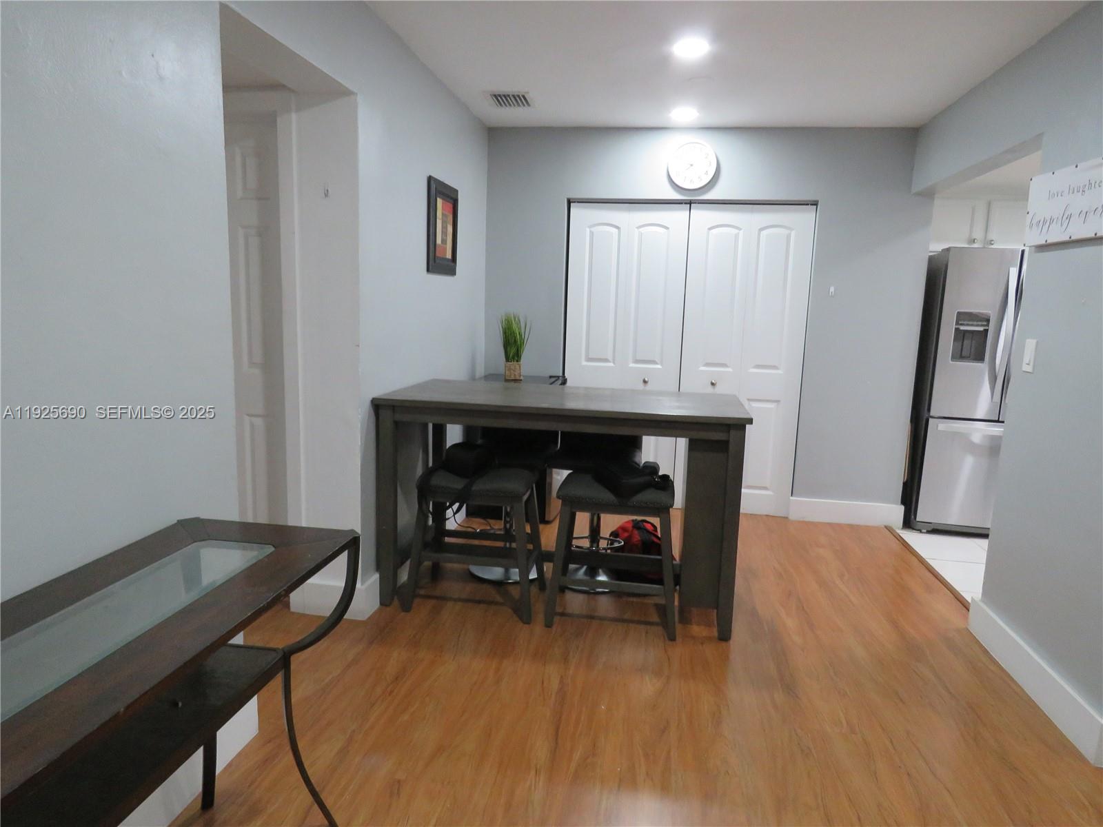 11840 Northeast 19th Drive, Unit 26 North Miami, FL 33181 - Photo 3 of 15 a view of a room with furniture and wooden floor