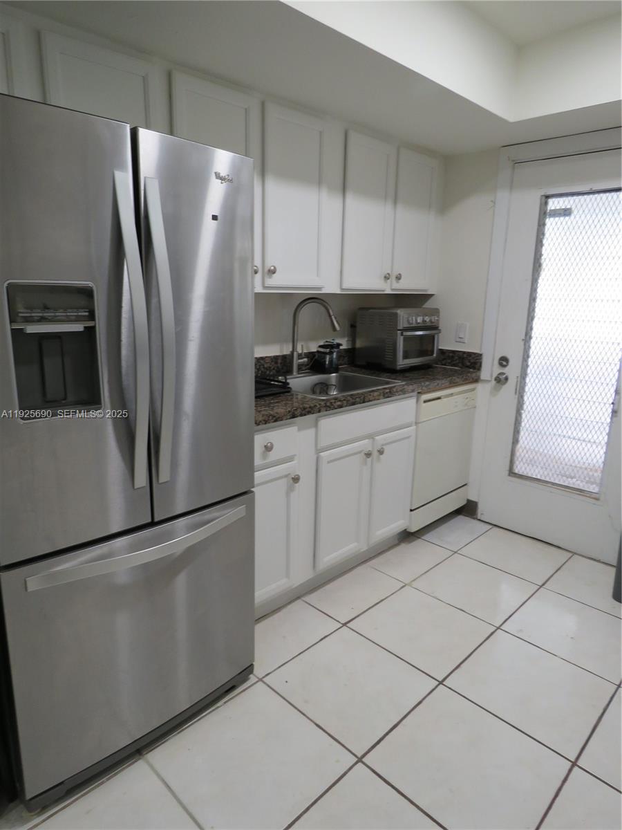 11840 Northeast 19th Drive, Unit 26 North Miami, FL 33181 - Photo 7 of 15 a kitchen with stainless steel appliances granite countertop a refrigerator and a sink