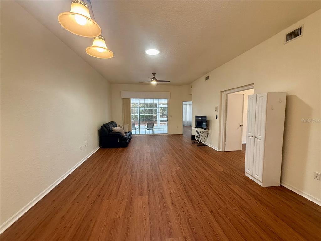 8037 Southwest 115th Loop Ocala, FL 34481 - Photo 12 of 47 a big room with wooden floor and windows