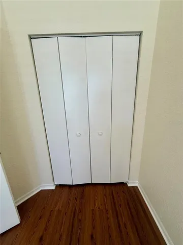 a view of a room with wooden floor