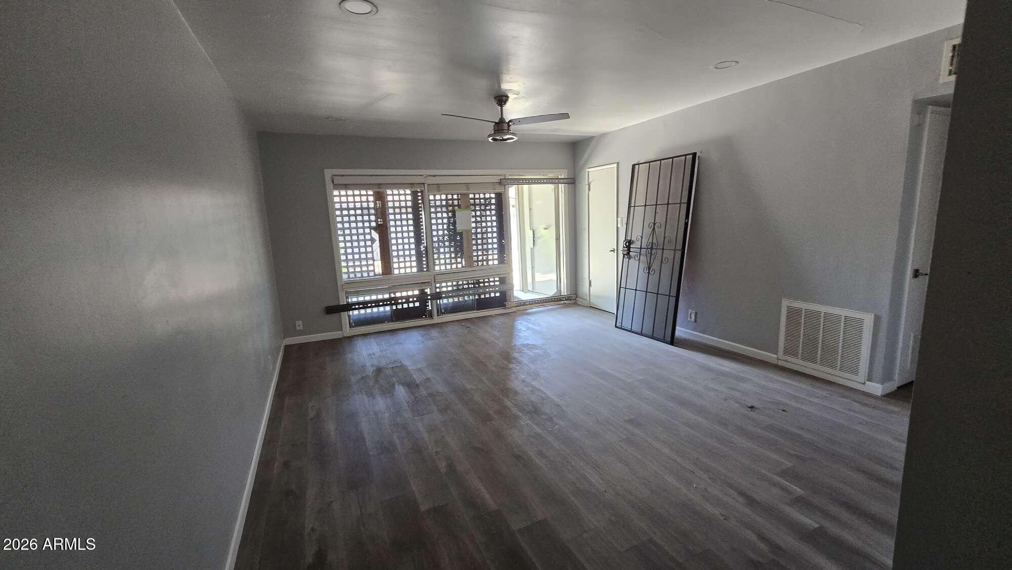 834 West Osborn Road Phoenix, AZ 85013 - Photo 17 of 45 an empty room with wooden floor and windows