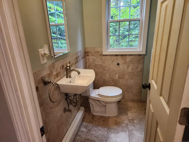 a bathroom with a sink toilet and a window