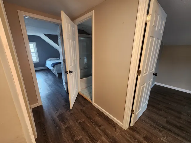 a bedroom with two bed and a window