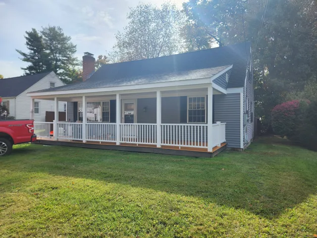 a view of a house with a yard and deck