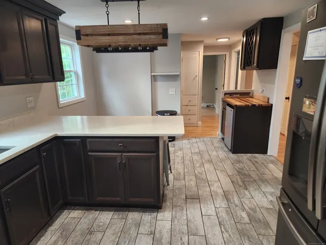 a kitchen with a refrigerator and a sink