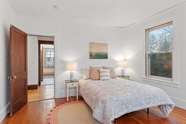 a bedroom with a bed and a large window