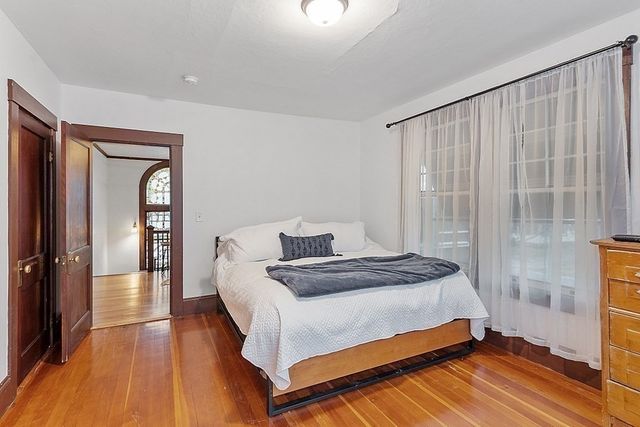 a bedroom with a bed and a mirror