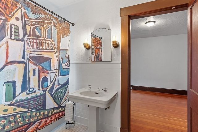 a view of an empty room with glass door and a window