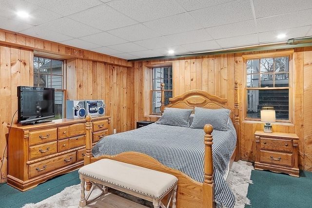 a bathroom with a sink a toilet a mirror and shower