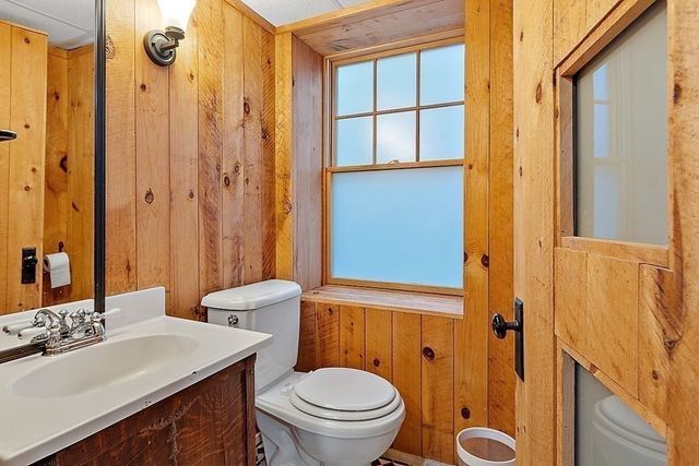 a view of an empty room with wooden floor and windows