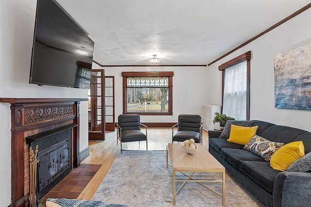 a living room with furniture and a fireplace