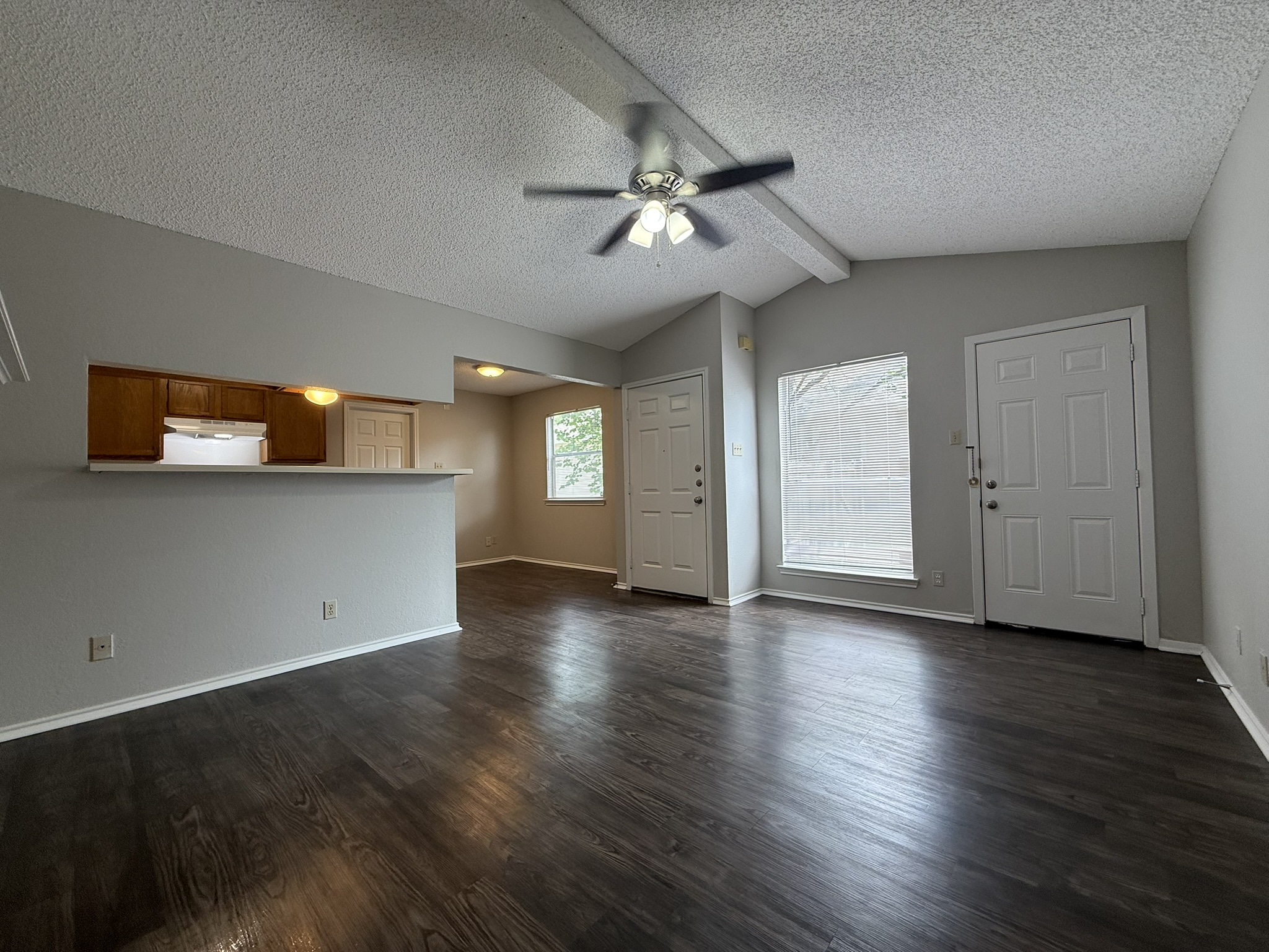 522 Cutty Trail, Unit B Lakeway, TX 78734 - Photo 5 of 20 A spacious living area with rich wood flooring and vaulted ceilings, ready for your personal touch.