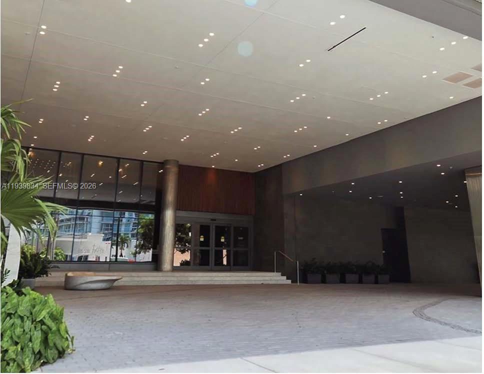 88 Southwest 7th Street, Unit 3403 Miami, FL 33130 - Photo 20 of 37 a view of a building with a potted plant and a window