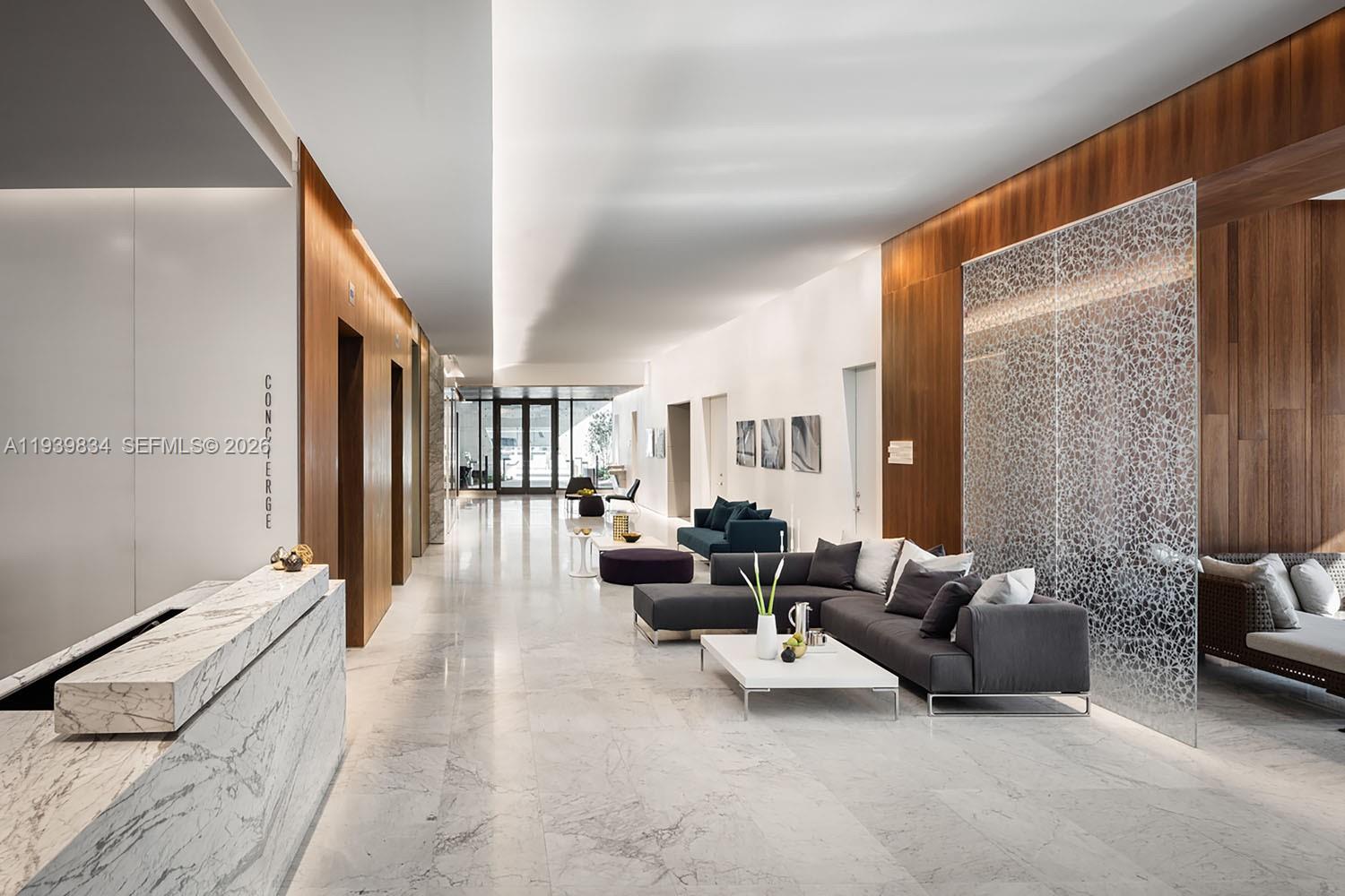 88 Southwest 7th Street, Unit 3403 Miami, FL 33130 - Photo 24 of 37 a living room with furniture and a floor to ceiling window