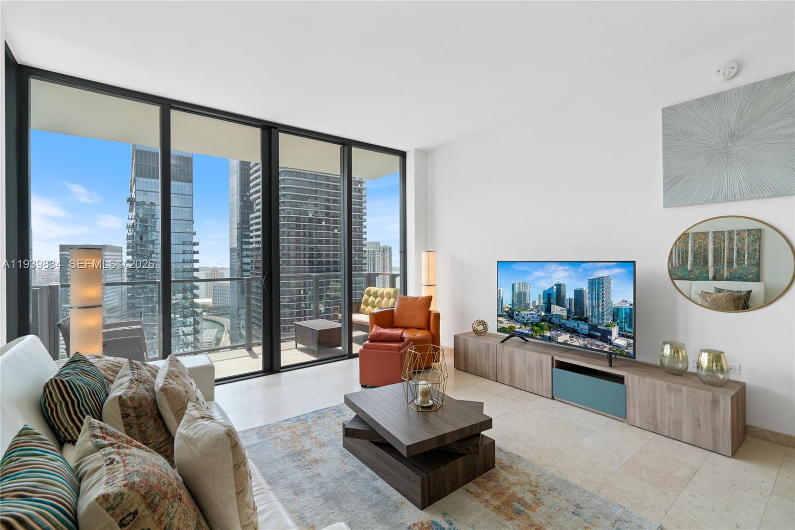 88 Southwest 7th Street, Unit 3403 Miami, FL 33130 - Photo 5 of 37 a living room with furniture and a floor to ceiling window