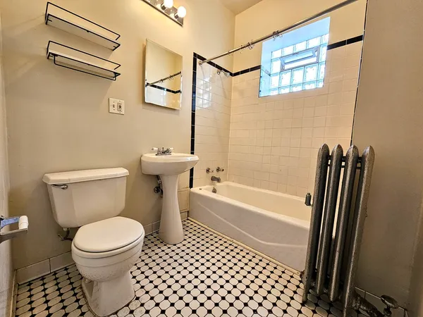 a bathroom with a toilet a sink and a shower