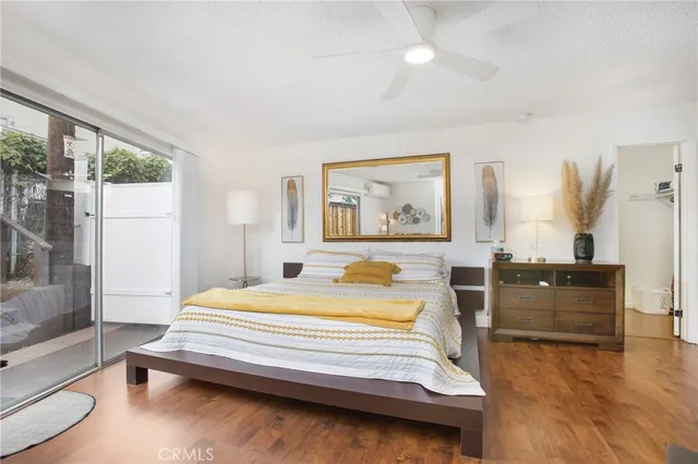 a bedroom with a bed and wooden floor