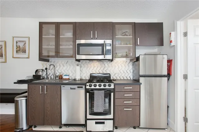 a kitchen with a stove microwave and sink
