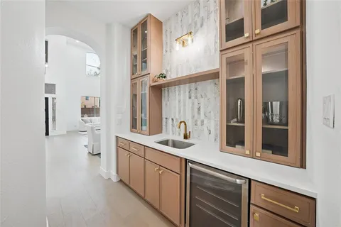 a large kitchen with kitchen island a large counter space appliances and a chandelier
