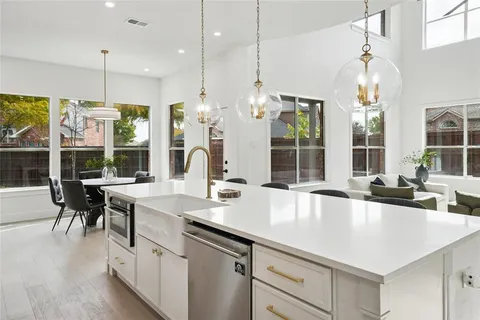 a large kitchen with a table and chairs