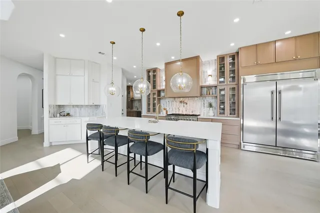 a kitchen with stainless steel appliances granite countertop a stove and a white cabinets