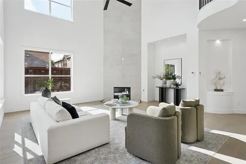 a living room with fireplace furniture and a floor to ceiling window