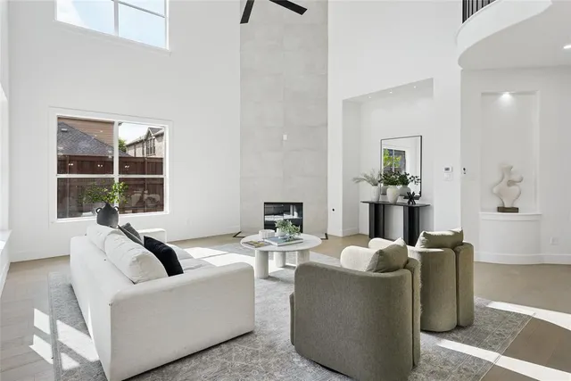 a living room with fireplace furniture and a floor to ceiling window