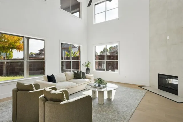 a living room with furniture potted plant and a large window