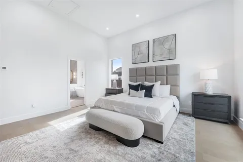 a spacious bedroom with a bed and a window