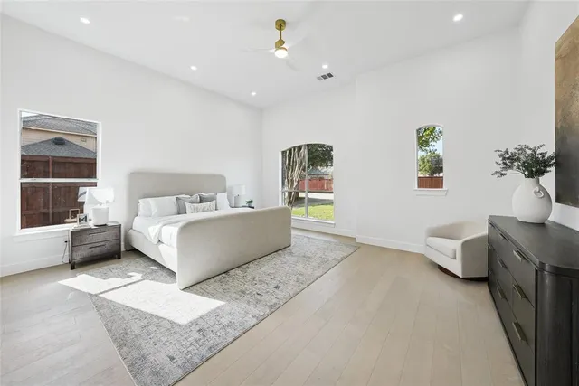 a bathroom with a double vanity sink mirror and bathtub