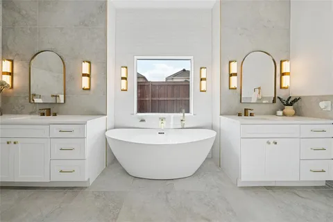 a white bath tub sitting next to a white sink