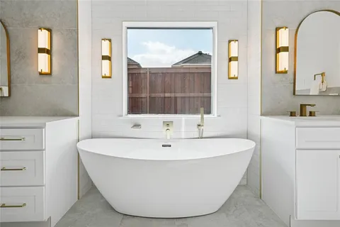 a bathroom with a double vanity sink mirror and shower