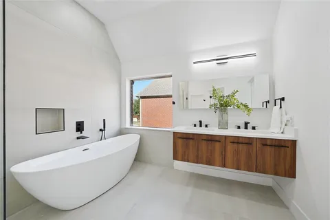 a white bath tub sitting next to a shower