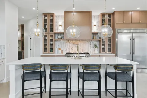 a kitchen with cabinets and chairs
