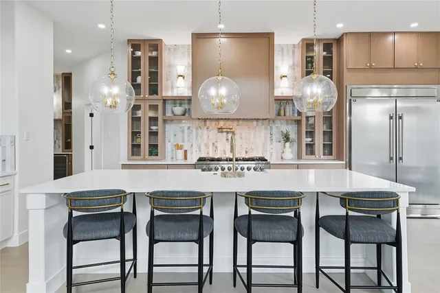 a kitchen with cabinets and chairs