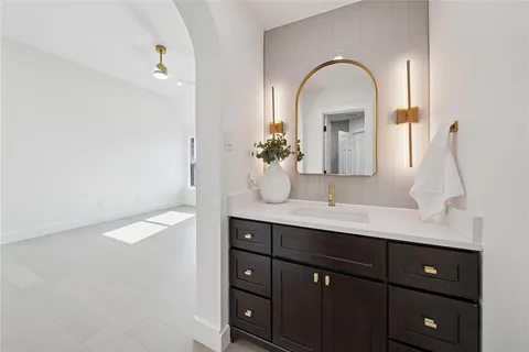 a spacious bathroom with a double vanity sink and a mirror