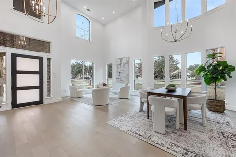a view of a dining room with furniture and a chandelier