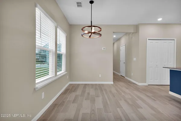 a kitchen with stainless steel appliances granite countertop a stove a sink dishwasher and a large refrigerator with wooden floor