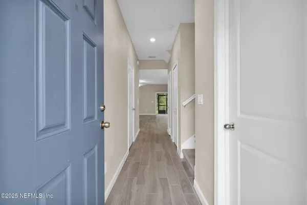 a view of a hallway with wooden floor