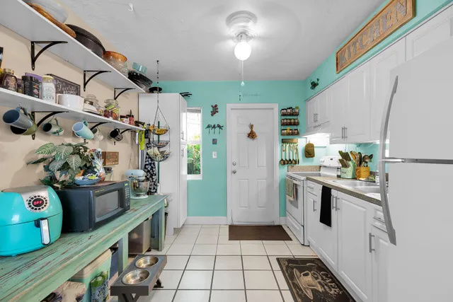 a living room with lots of furniture and clutter