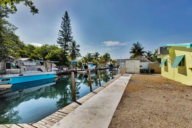 a view of yard from deck with patio