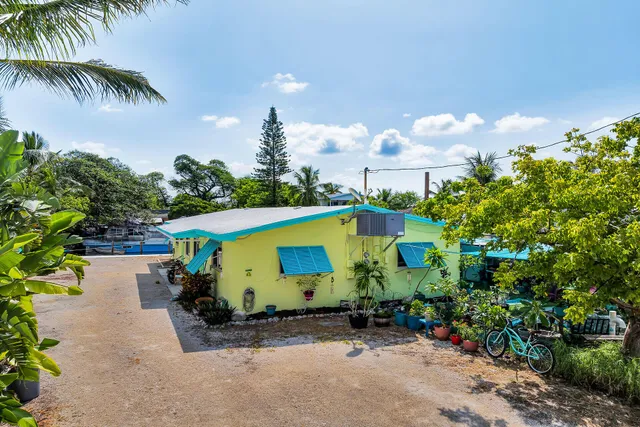 an aerial view of a house with a yard and a sitting area
