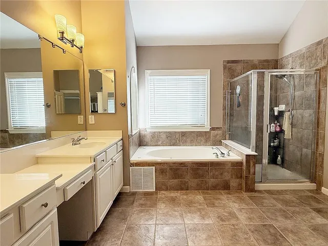 a bathroom with a bathtub and a shower