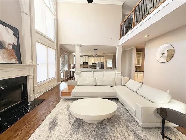 a living room with furniture a fireplace and a large window